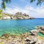 Beautiful beach with turquoise water and cliffs.